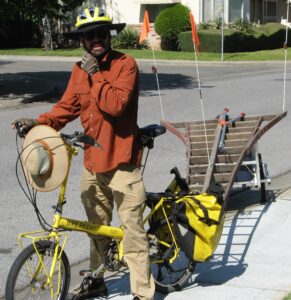 Dave with pruning ladder as a trailer for his bicycle